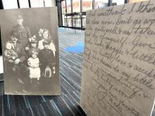 A picture of a solider and his family to the left, a copy of a letter in the foreground