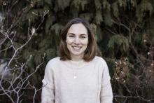 Kimberly Coleman, a woman is standing in front of trees