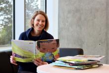 A woman reading childrens picture books 