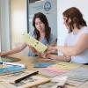 VIU Research Assistants Elise Cullon and Katie Carroll. Katie shows Elise a document.