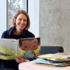 A woman reading childrens picture books 